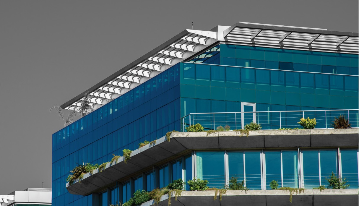 a building with windows and plants