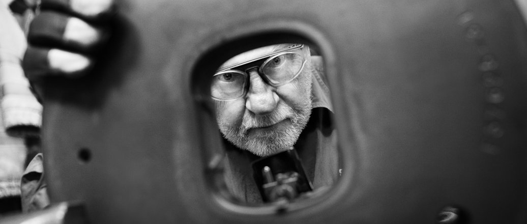Worker looking through steel die Worker looking through steel die