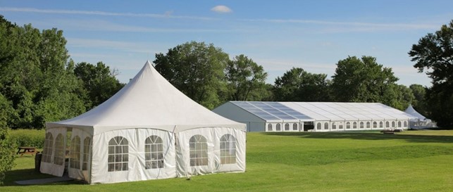 a white building with a green lawn