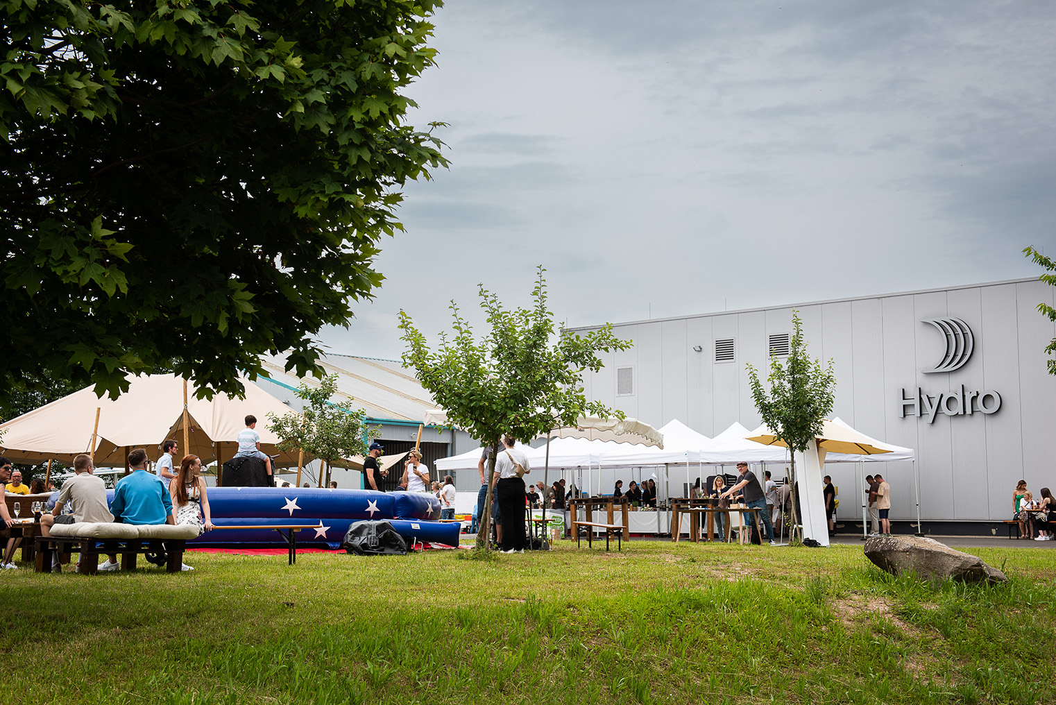a group of people outside with tents and trees
