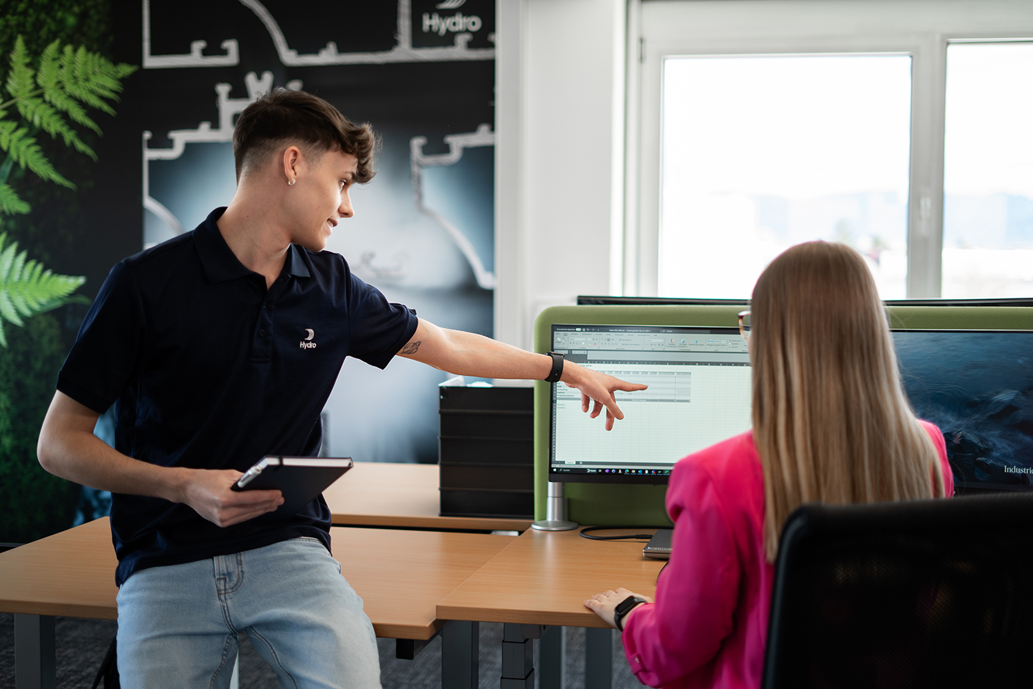 a man pointing at a computer screen