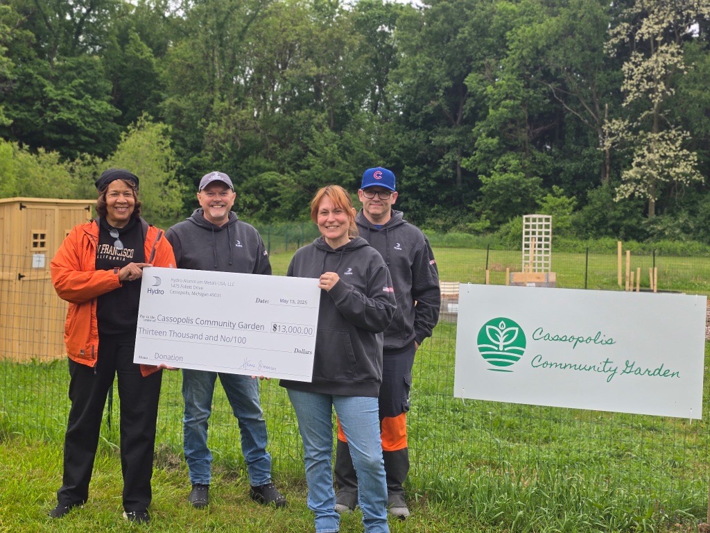 a group of people holding a check