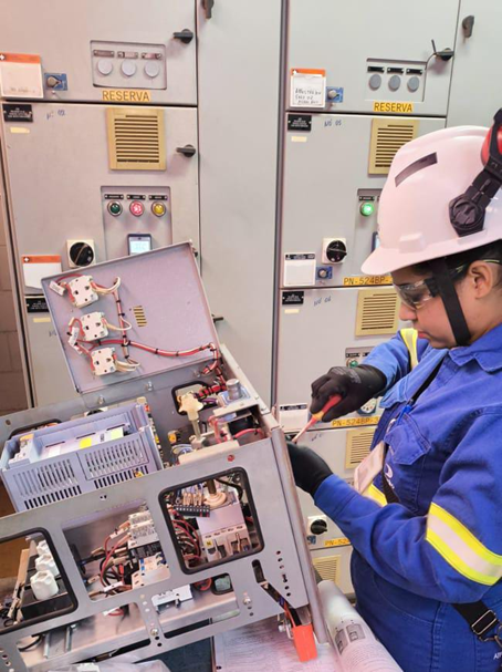 a person wearing a hard hat and protective gear working in a factory
