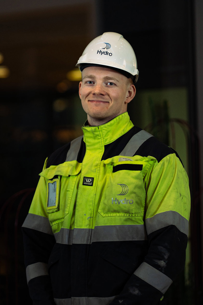 a man in a reflective jacket and white hard hat
