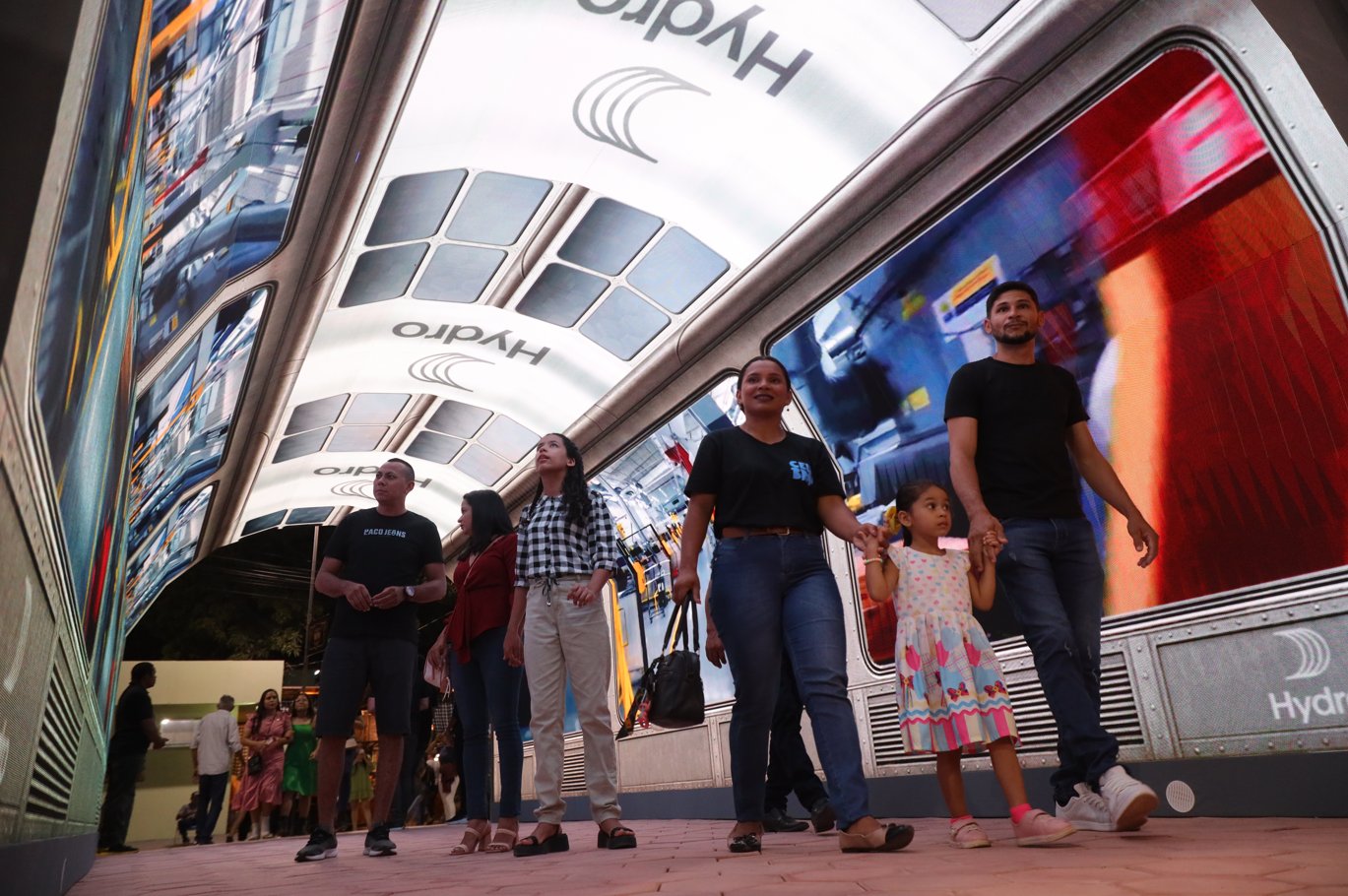a group of people standing in front of a large glass building
