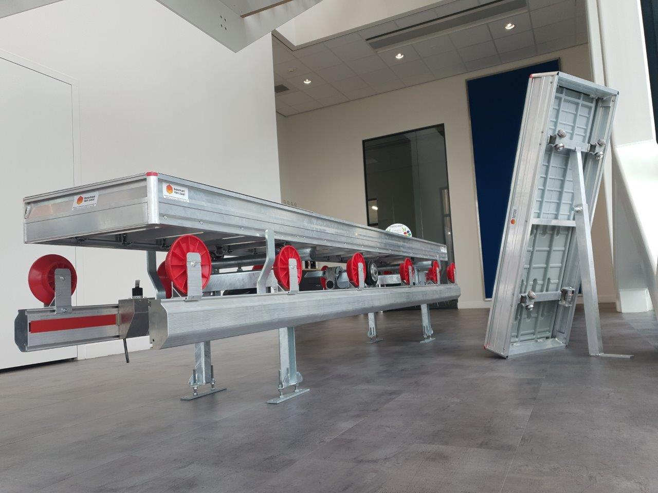 a metal conveyor belt in a room
