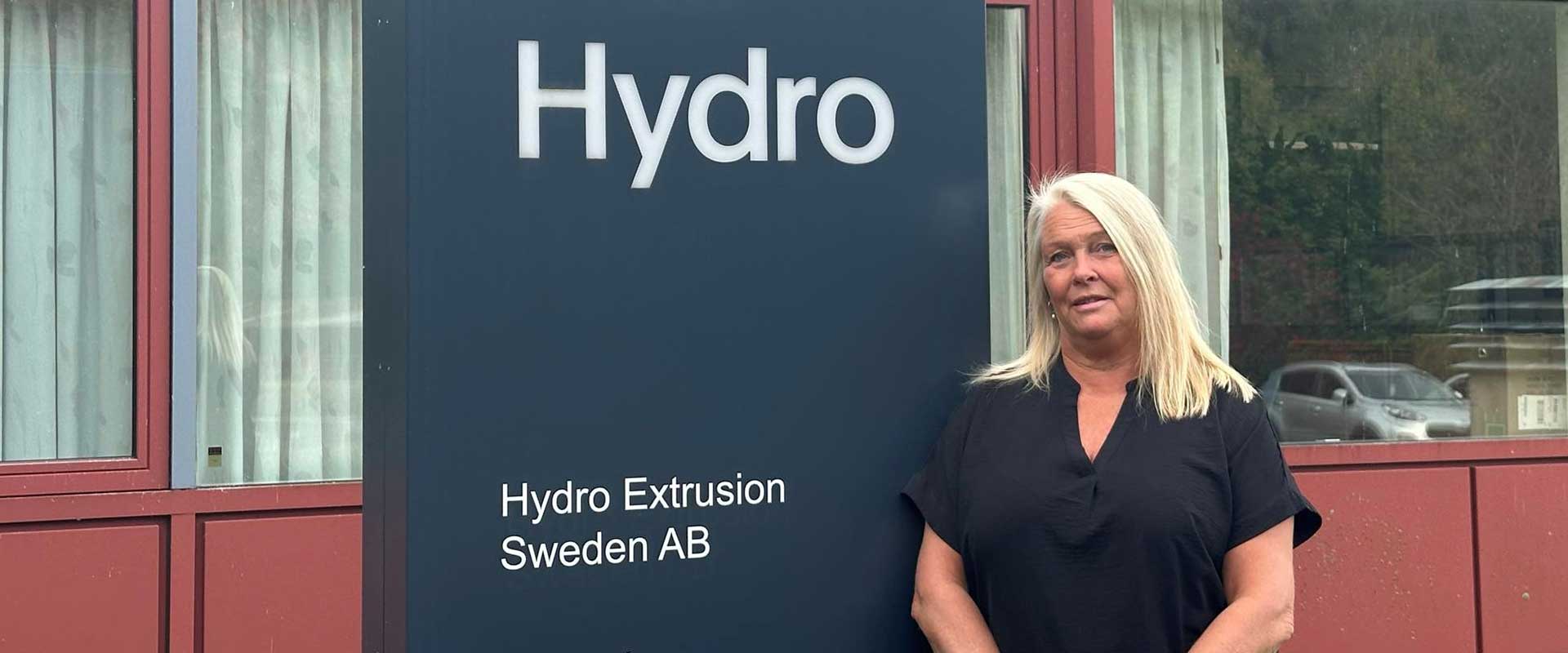 a person standing in front of a sign